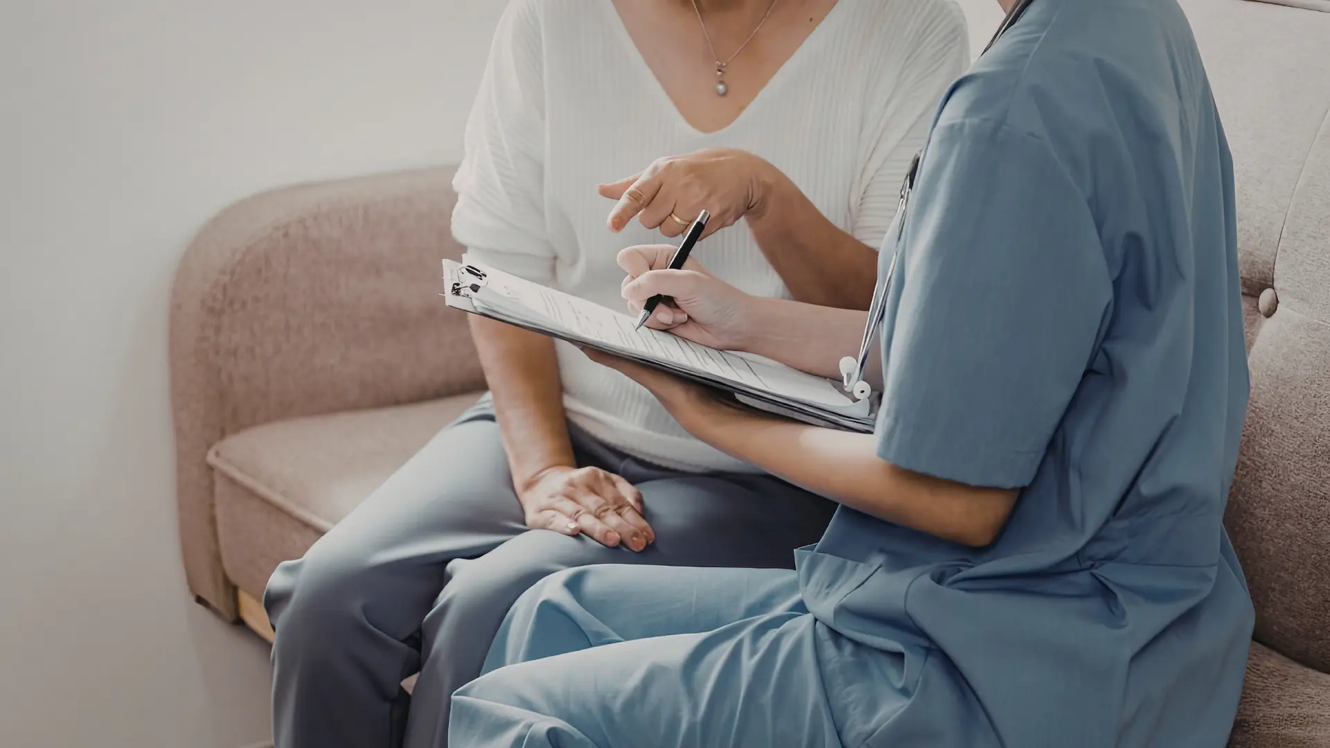 A clinician reviewing appointment paperwork with a patient